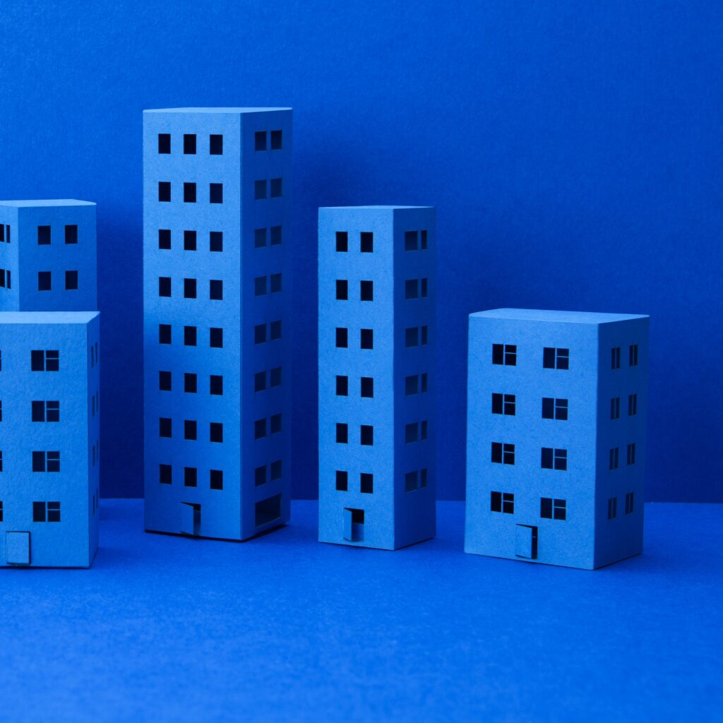 Miniature houses on blue background.